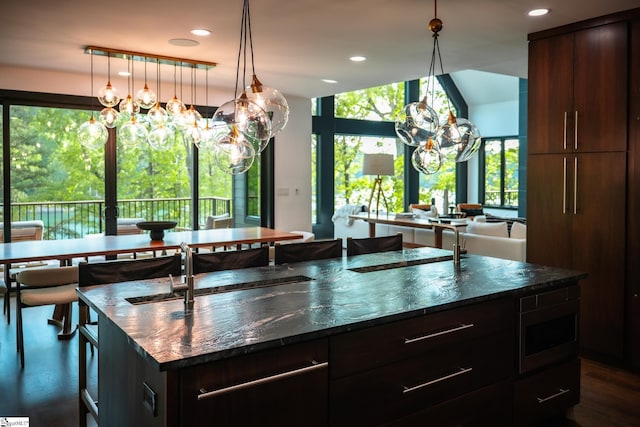 kitchen with recessed lighting, stainless steel microwave, and a notable chandelier