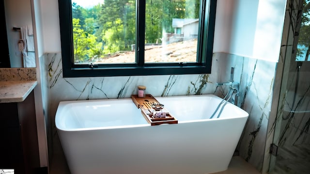 bathroom featuring a freestanding bath and tile walls