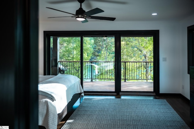 bedroom with recessed lighting, dark wood-style flooring, multiple windows, and access to exterior