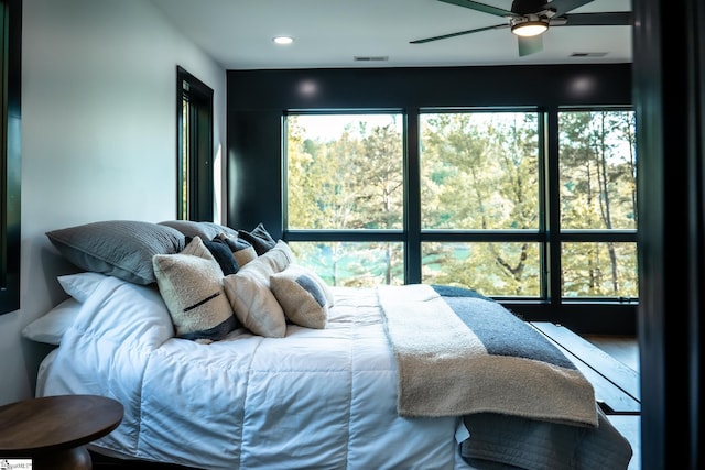 bedroom featuring recessed lighting, visible vents, and multiple windows