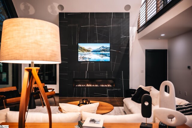 interior space featuring a tiled fireplace and wood finished floors
