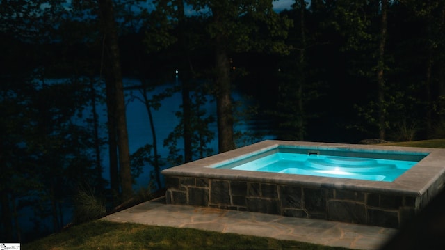 view of pool with an in ground hot tub