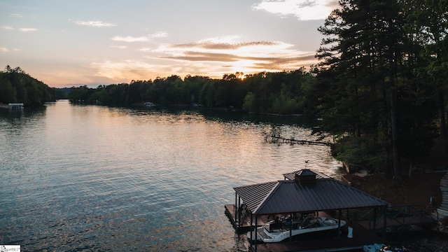 dock area with a view of trees and a water view