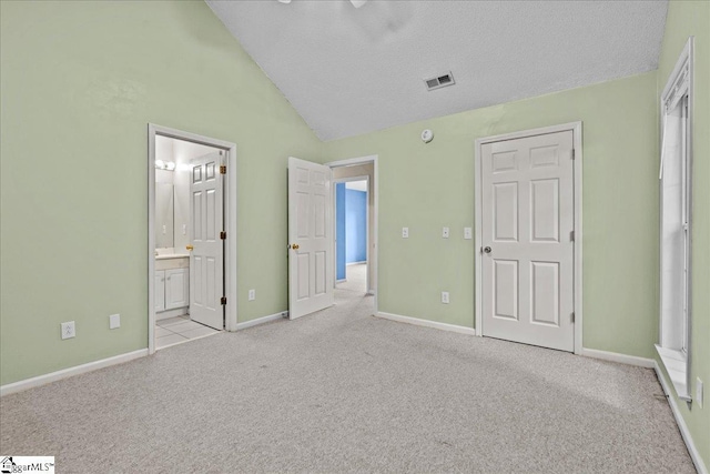 unfurnished bedroom featuring a textured ceiling, visible vents, vaulted ceiling, baseboards, and carpet