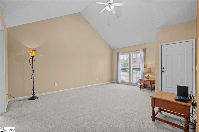 living area with light colored carpet, a ceiling fan, baseboards, and lofted ceiling