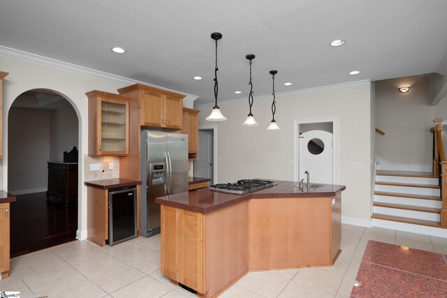 kitchen with a kitchen island, light tile patterned floors, beverage cooler, glass insert cabinets, and stainless steel appliances