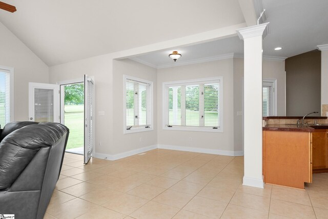 living room featuring crown molding, a wealth of natural light, and light tile patterned floors