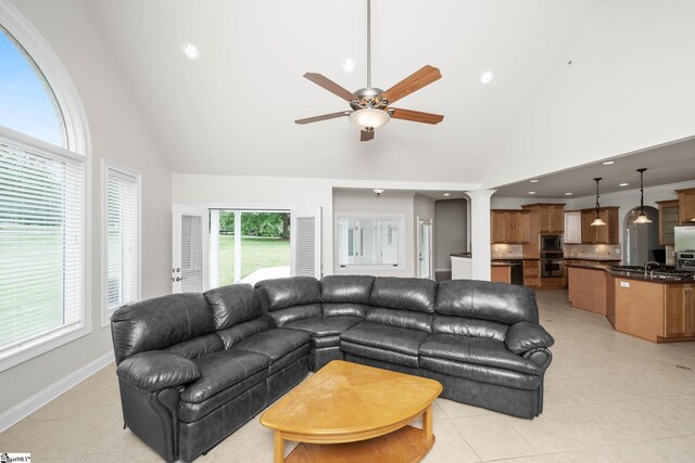 living room with light tile patterned floors, high vaulted ceiling, ceiling fan, and recessed lighting