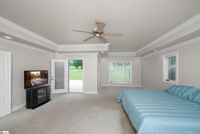carpeted bedroom with access to outside, baseboards, crown molding, and a tray ceiling