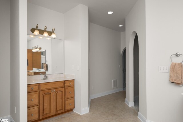 bathroom with recessed lighting, baseboards, visible vents, and vanity