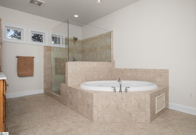 bathroom with visible vents, a garden tub, baseboards, walk in shower, and recessed lighting