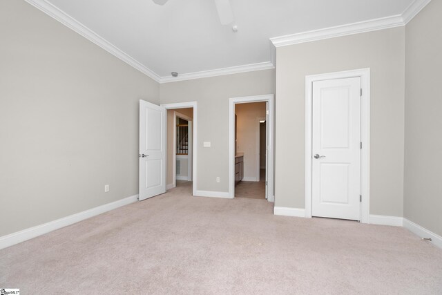 unfurnished bedroom with connected bathroom, ceiling fan, light carpet, baseboards, and ornamental molding