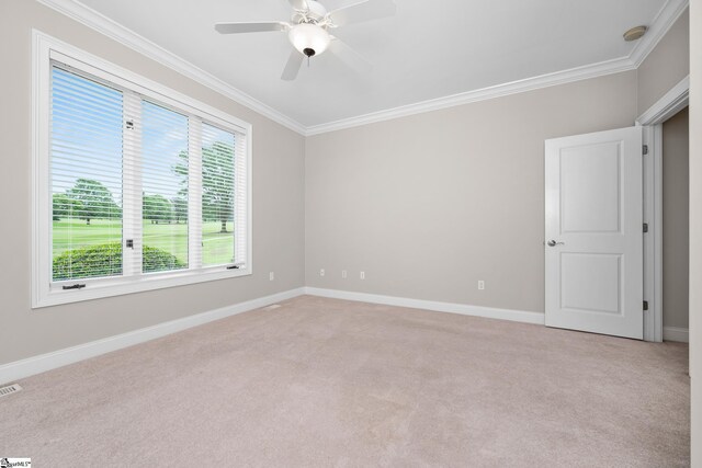 empty room with baseboards, ornamental molding, ceiling fan, and light carpet