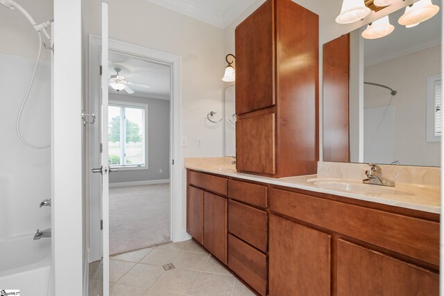 full bathroom with crown molding, a sink, double vanity, tile patterned floors, and shower / washtub combination