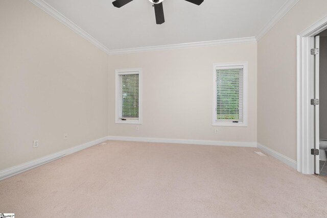 unfurnished room featuring crown molding, ceiling fan, light carpet, and baseboards