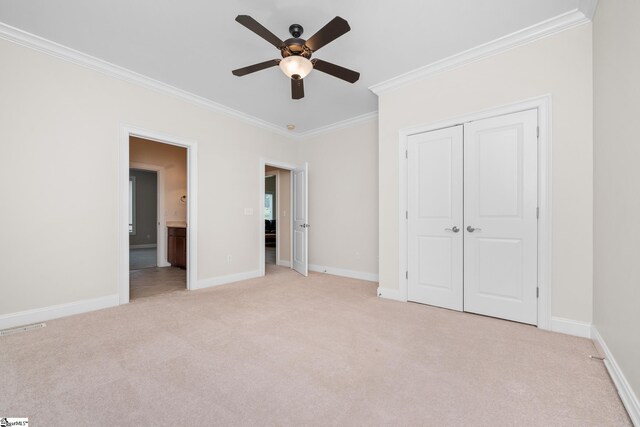 unfurnished bedroom with crown molding, a closet, visible vents, light carpet, and baseboards
