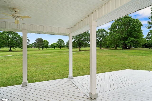 deck featuring a lawn and a ceiling fan