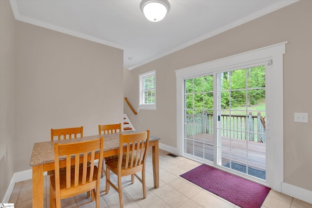 dining area featuring visible vents, ornamental molding, baseboards, stairway, and light tile patterned floors