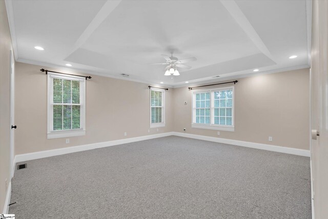 unfurnished room featuring visible vents, baseboards, recessed lighting, a tray ceiling, and a ceiling fan