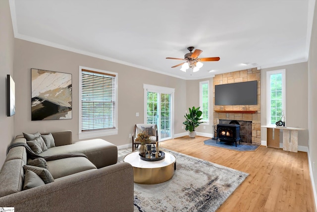 49 Pleasant Valley Trl, Travelers Rest, SC 29690 - living area with a wood stove, ornamental molding, light wood-style floors, baseboards, and healthy amount of natural light