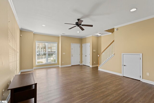 unfurnished living room featuring ornamental molding, stairs, a ceiling fan, baseboards, and dark wood-style floors