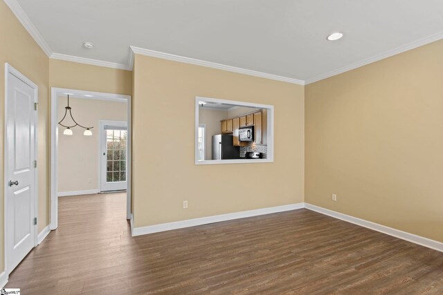unfurnished room featuring crown molding, recessed lighting, baseboards, and dark wood finished floors