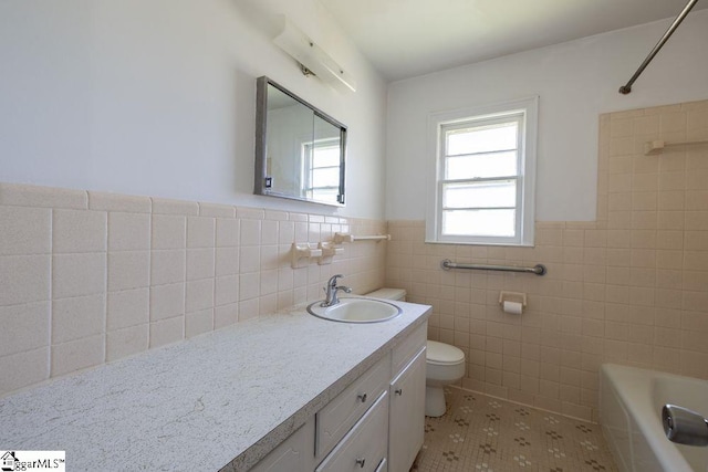 2403 Dobbins Bridge Rd, Anderson, SC 29626 - bathroom with vanity, toilet, tile walls, and a wainscoted wall