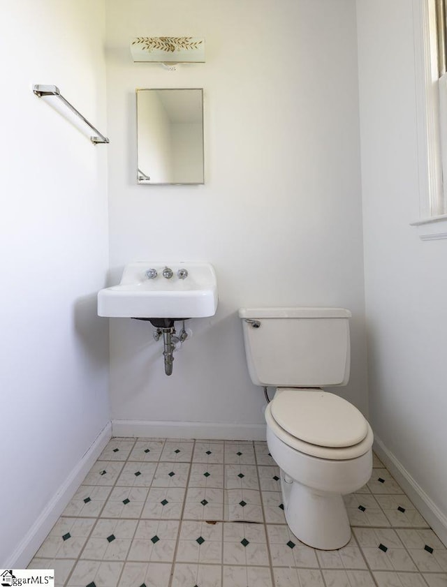 2403 Dobbins Bridge Rd, Anderson, SC 29626 - bathroom with toilet, tile patterned floors, a sink, and baseboards