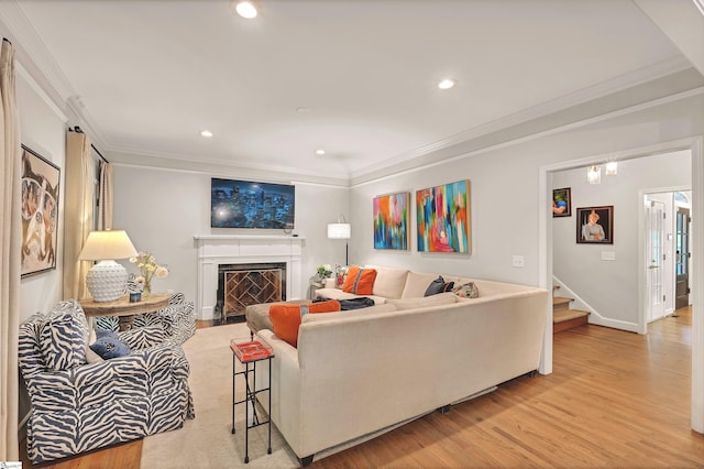 living area with stairway, recessed lighting, ornamental molding, and light wood-type flooring
