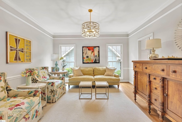 living room with an inviting chandelier, crown molding, and wood finished floors