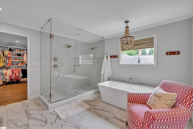 bathroom with a shower stall, marble finish floor, a spacious closet, ornamental molding, and a soaking tub