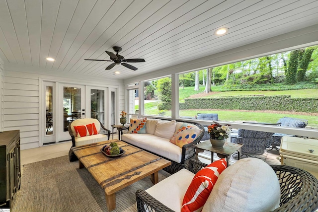 sunroom / solarium with a ceiling fan, outdoor lounge area, and french doors
