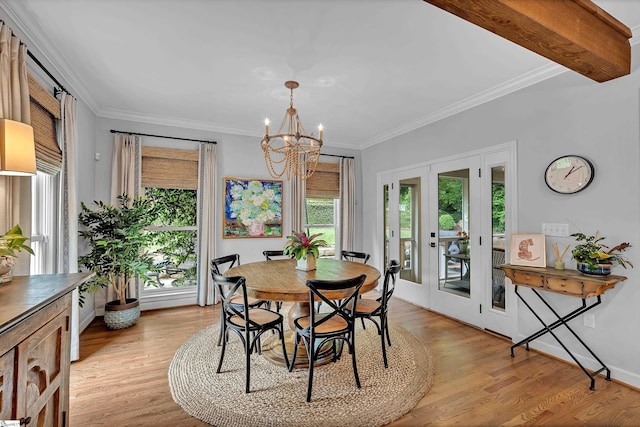 dining area featuring light wood-style flooring, a chandelier, and a wealth of natural light