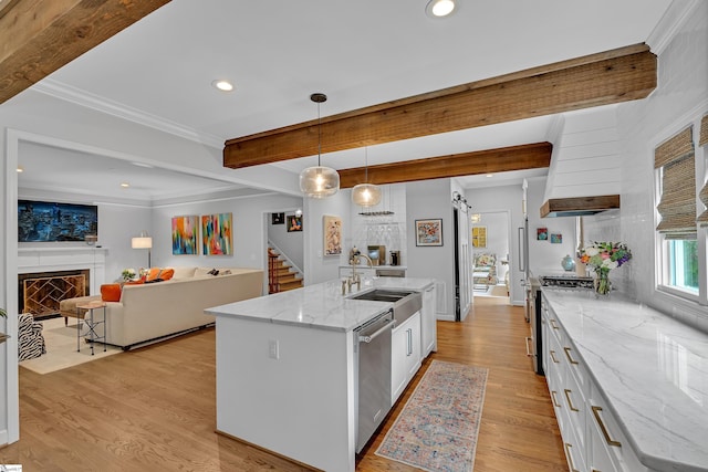 kitchen with white cabinets, appliances with stainless steel finishes, a sink, recessed lighting, and light wood-type flooring