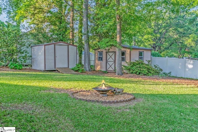 207 Tollgate Rd, Simpsonville, SC 29681 - view of yard with an outbuilding, an outdoor fire pit, fence, and a storage shed