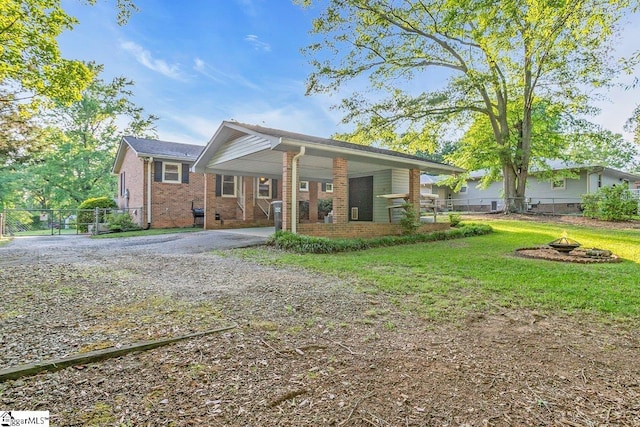 207 Tollgate Rd, Simpsonville, SC 29681 - rear view of house with fence, an outdoor fire pit, brick siding, a carport, and driveway