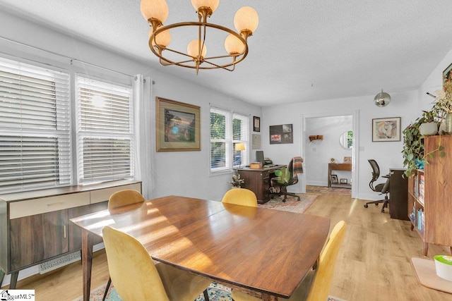 207 Tollgate Rd, Simpsonville, SC 29681 - dining area with visible vents, a textured ceiling, light wood-style flooring, and a notable chandelier