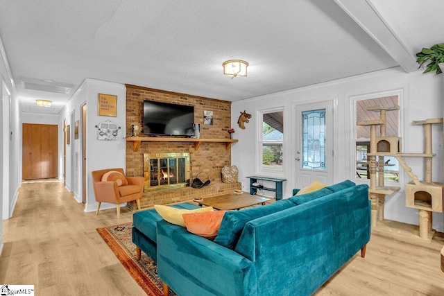 207 Tollgate Rd, Simpsonville, SC 29681 - living room with a brick fireplace, a textured ceiling, ornamental molding, and wood finished floors