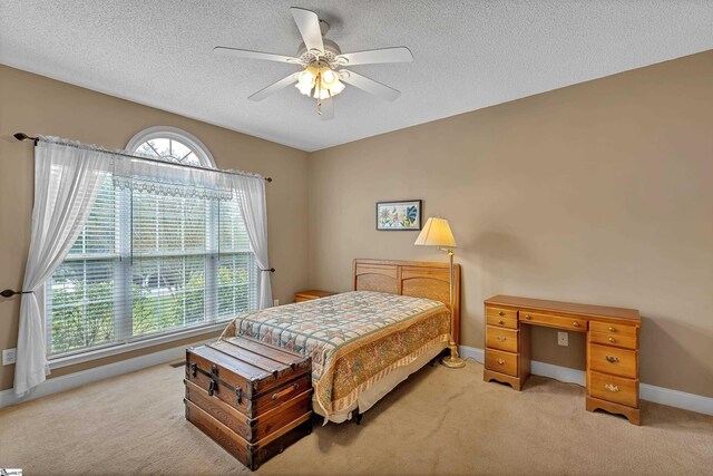 201 Cedar Creek Ln, Seneca, SC 29678 - bedroom with light colored carpet, a textured ceiling, baseboards, and a ceiling fan