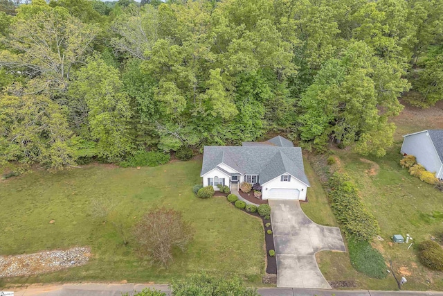 birds eye view of property with a forest view