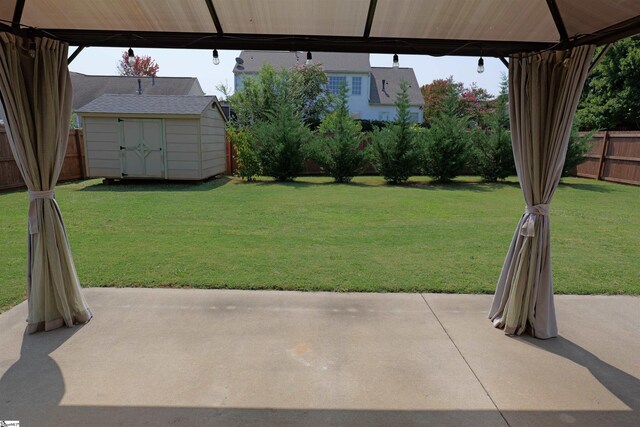 502 E Heatherstone Ln, Roebuck, SC 29376 - view of yard with an outdoor structure, a fenced backyard, a patio area, and a storage shed