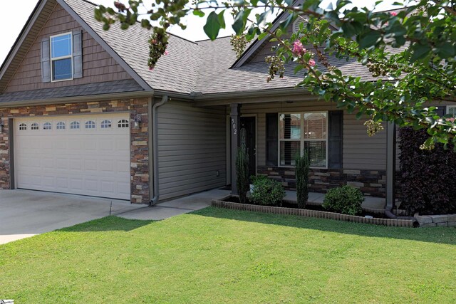 502 E Heatherstone Ln, Roebuck, SC 29376 - craftsman-style home featuring a garage, a front lawn, covered porch, and stone siding