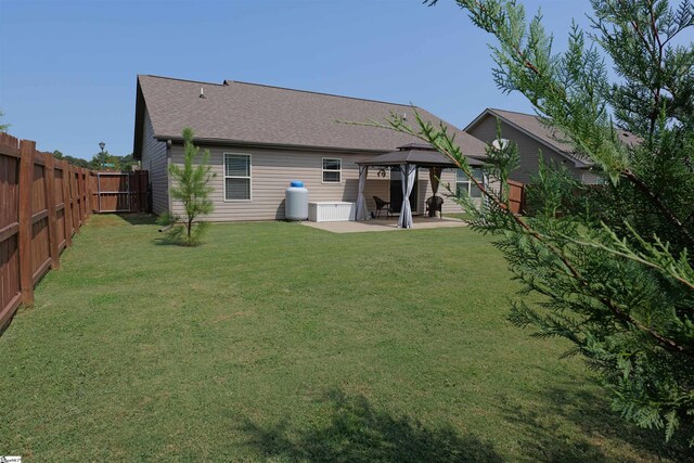 502 E Heatherstone Ln, Roebuck, SC 29376 - rear view of property featuring a yard, a patio, a gazebo, and a fenced backyard