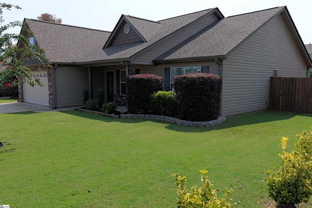 502 E Heatherstone Ln, Roebuck, SC 29376 - craftsman-style home with an attached garage, fence, a shingled roof, and a front yard