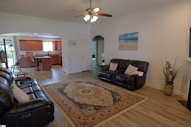 502 E Heatherstone Ln, Roebuck, SC 29376 - living room with light wood-type flooring, arched walkways, baseboards, and a ceiling fan
