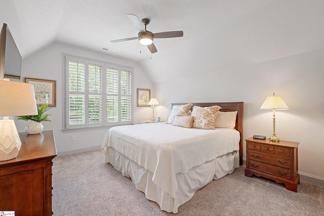 bedroom featuring vaulted ceiling, light carpet, and visible vents