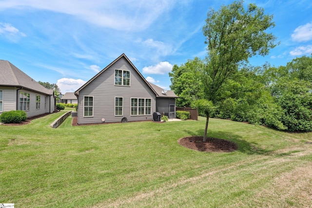 rear view of house featuring a lawn