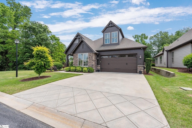 craftsman-style house with a front yard, driveway, and stone siding