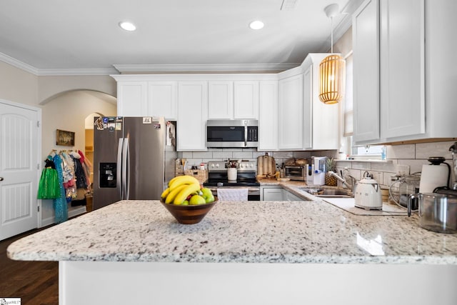 180 Bur Oak Dr, Taylors, SC 29687 - kitchen featuring crown molding, light stone countertops, a sink, arched walkways, and stainless steel appliances