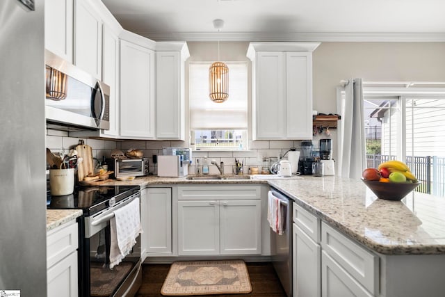 180 Bur Oak Dr, Taylors, SC 29687 - kitchen with decorative backsplash, a peninsula, white cabinetry, a sink, and appliances with stainless steel finishes